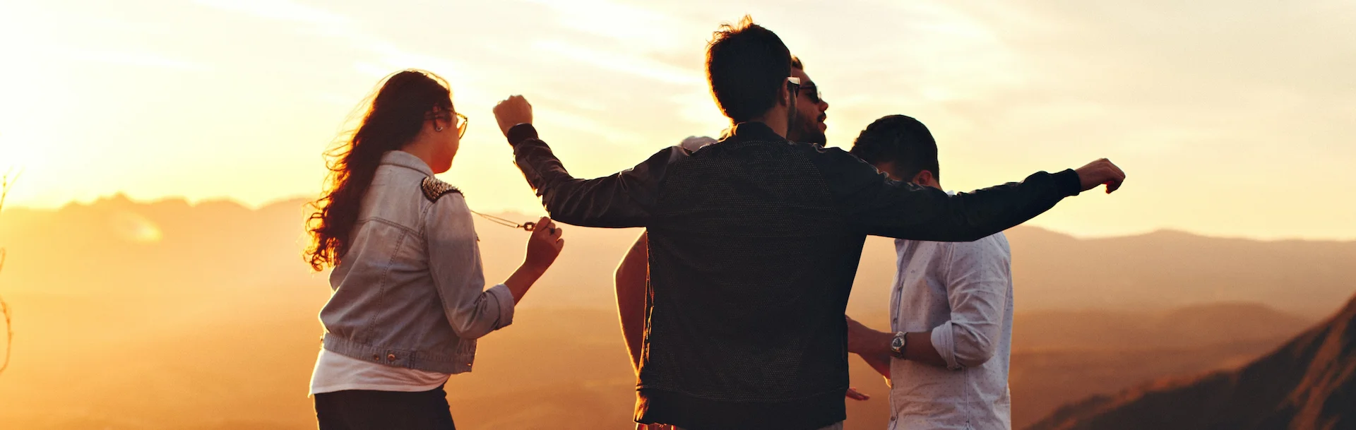 Adult friends together outdoors at sunset